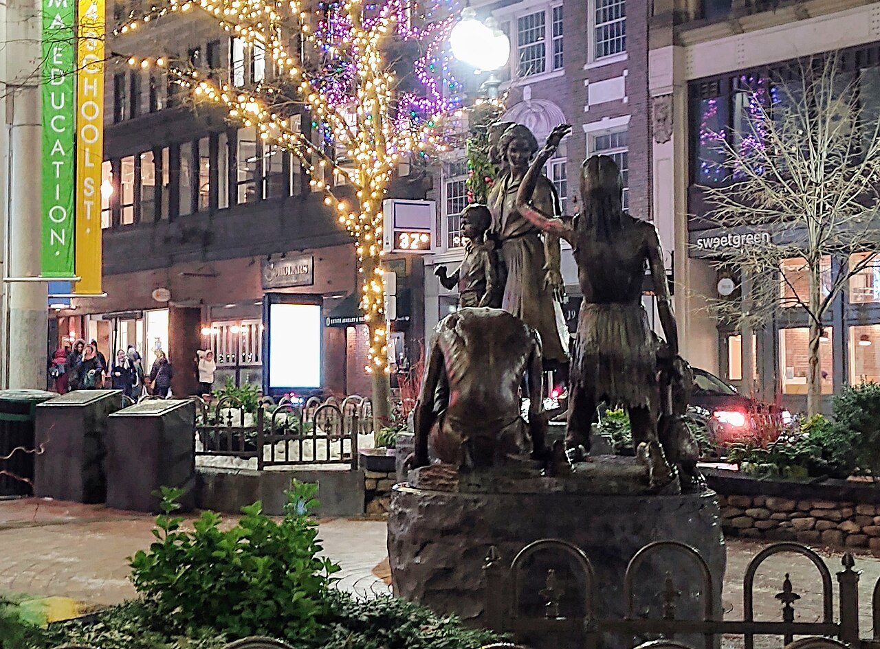 The Boston Irish Famine Memorial by night in Downtown Crossing: bronze figures of a starving family